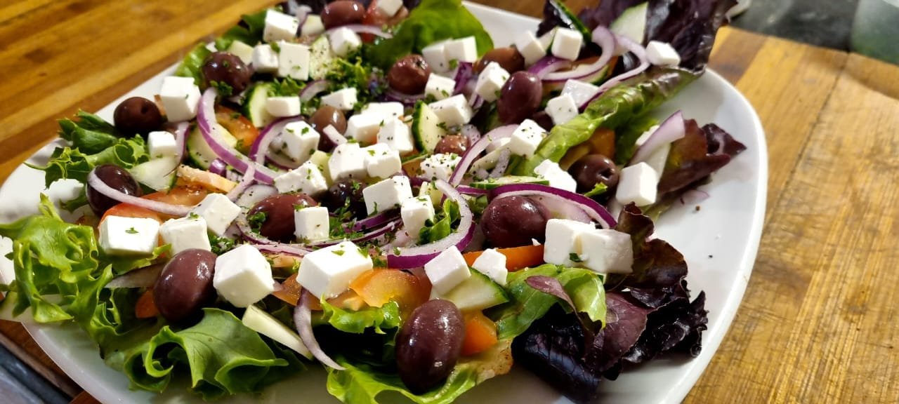 Greek salad with feta, olives, red onion and mixed leaves