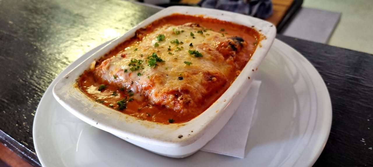 Lasagna baked with a bubbling cheese and tomato topping