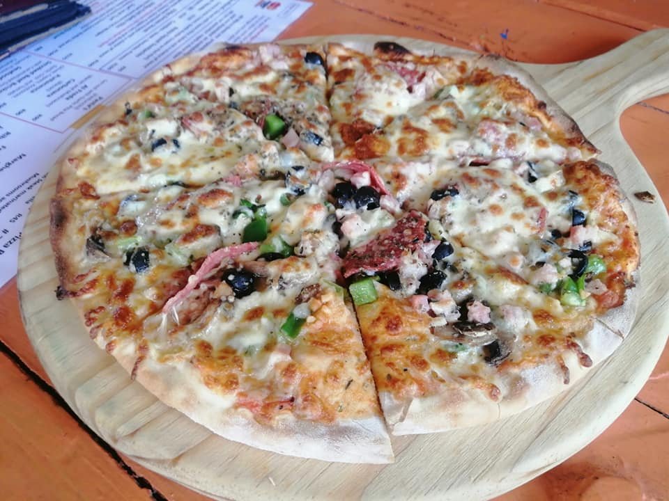 Wood-fired pizza, sliced and ready to serve