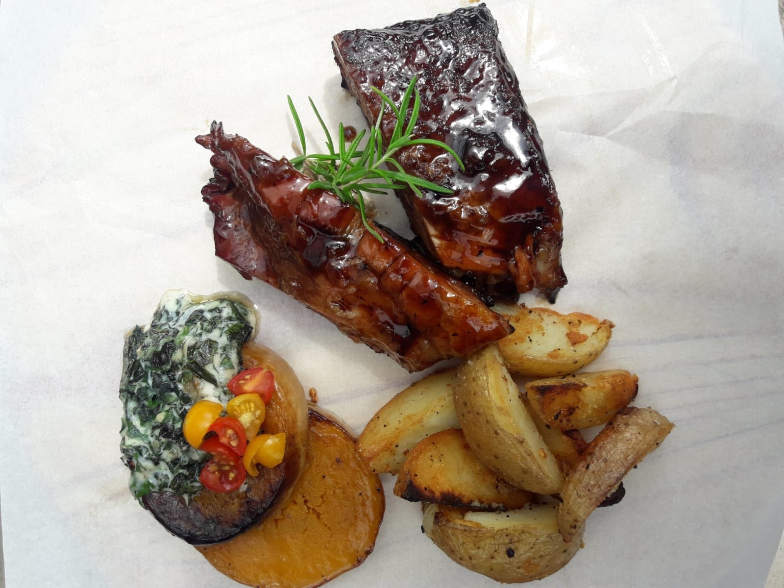 Glazed pork ribs with creamed spinach, butternut and roasted potatoes