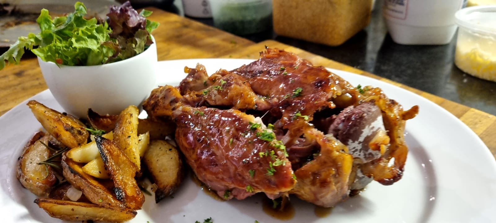 Roasted chicken with potato wedges and a side salad