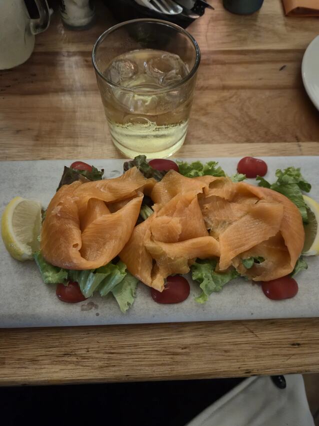 Smoked trout starter with salad leaves, baby tomato and lemon at Gavin's Trattoria