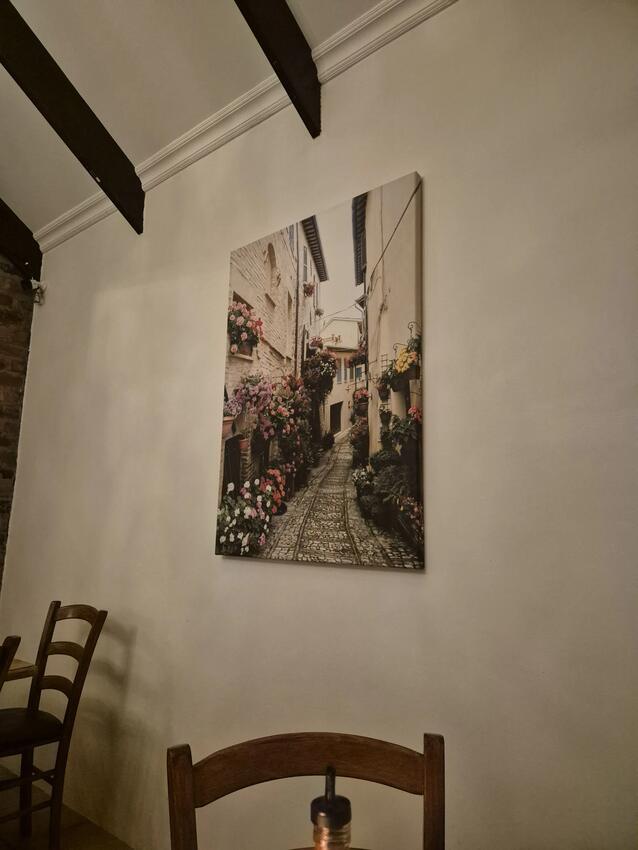 Italian street scene artwork on the dining room wall at Gavin's Trattoria