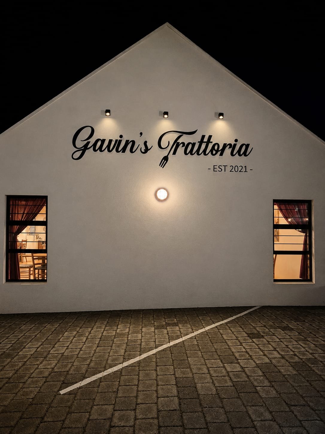 Gavin's Trattoria, lit up at night in L'Agulhas