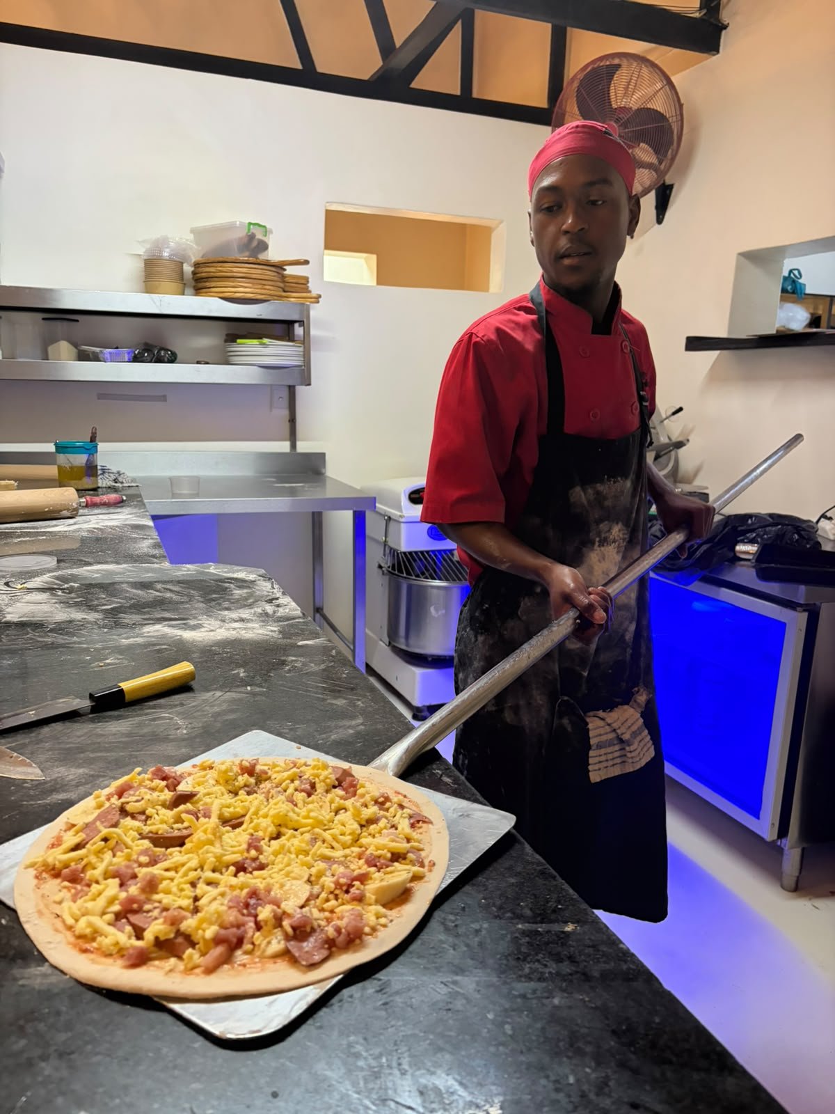 Pizza being prepared in the kitchen
